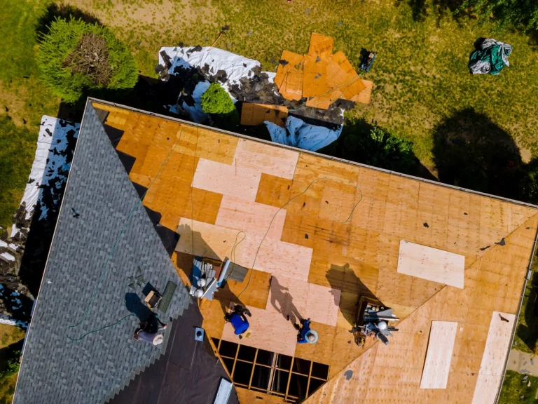 roofing crew replacing the damaged roof