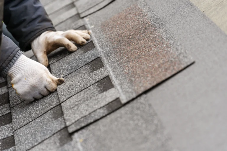 how to patch a shingle roof-gloved hands installing new shingles