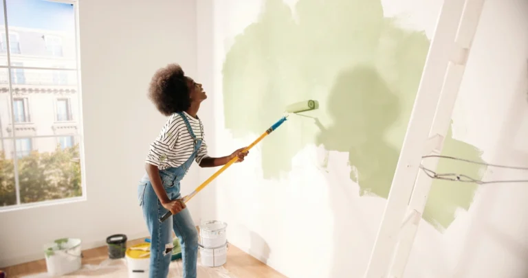 renovation vs remodel-woman painting interior walls