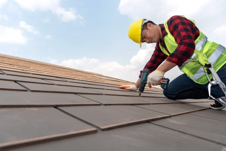 roof installation-close up of roof tech installing roofing materials