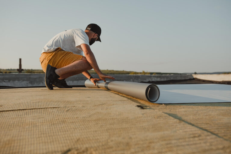 pvc roofing-worker installing pvc roofing on a commercial flat roof