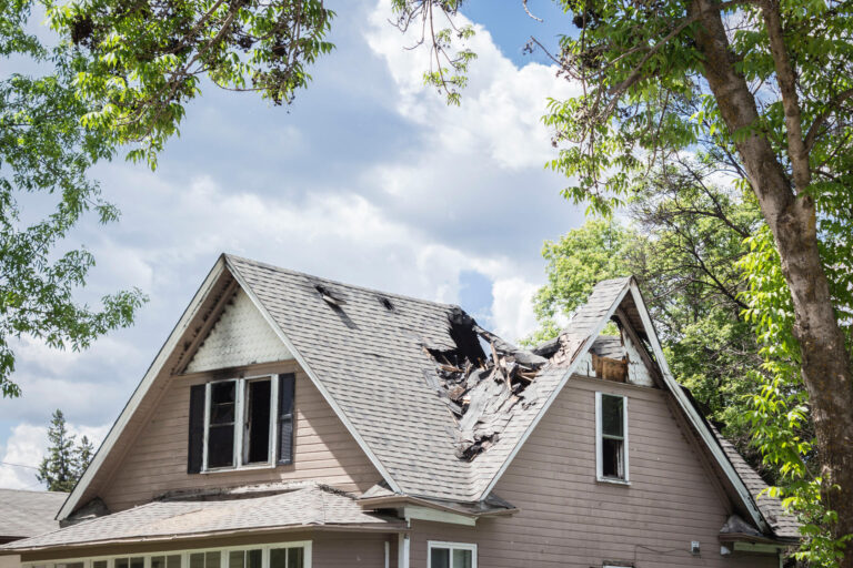 roof insurance claim-severely damaged roofing with a large portion destroyed