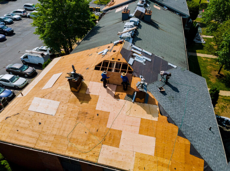 new roof installation-arial view of roofing crew installing new roof on a home