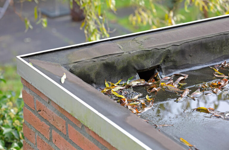 flat roof drainage-roof scupper with water and debris