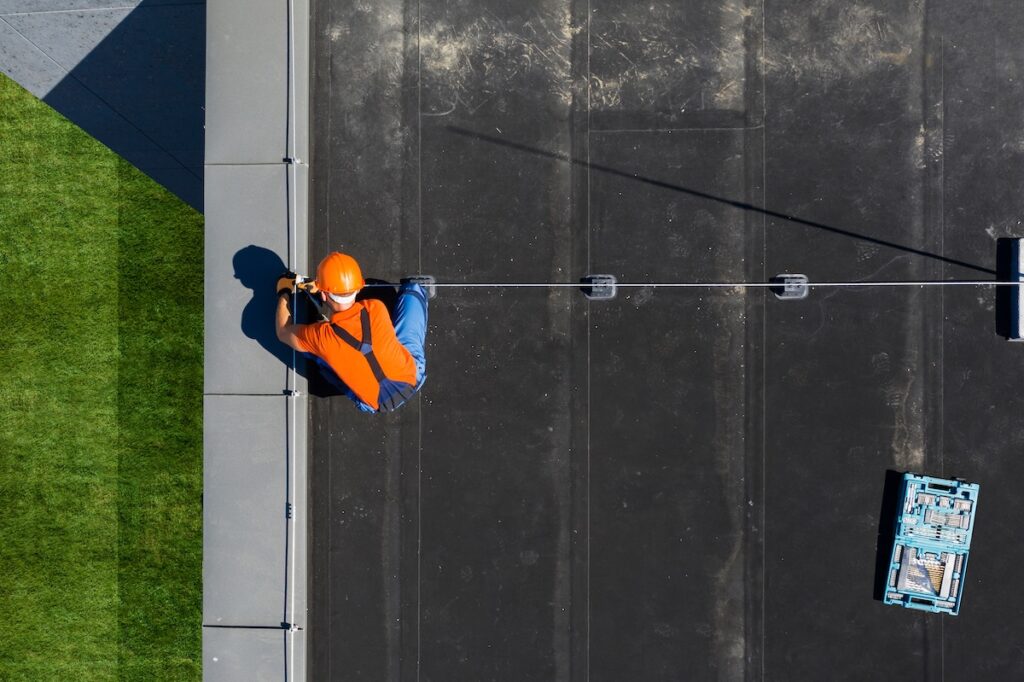 Roofer installing commercial roofing system