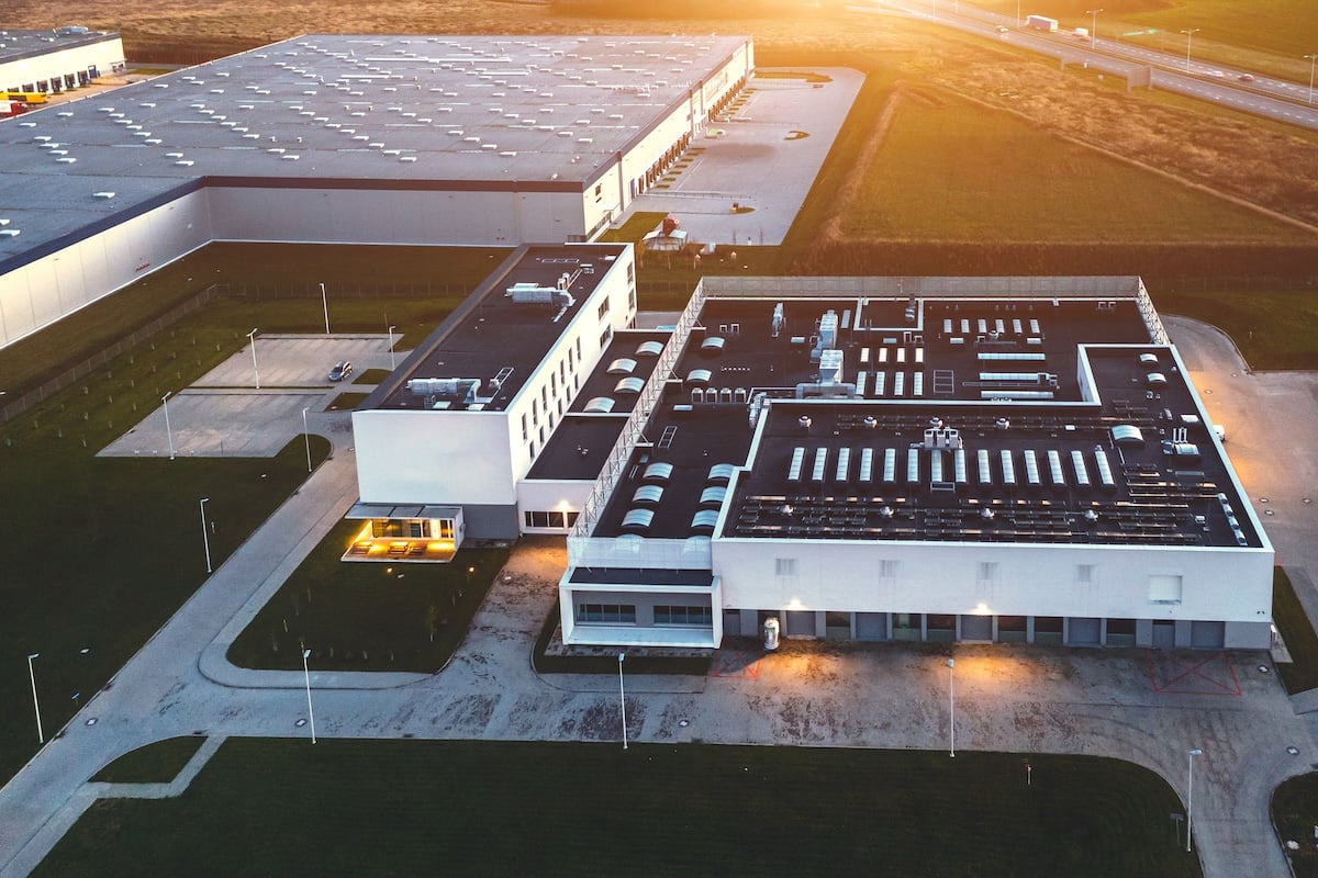 Aerial view of a large commercial building with new roofing system