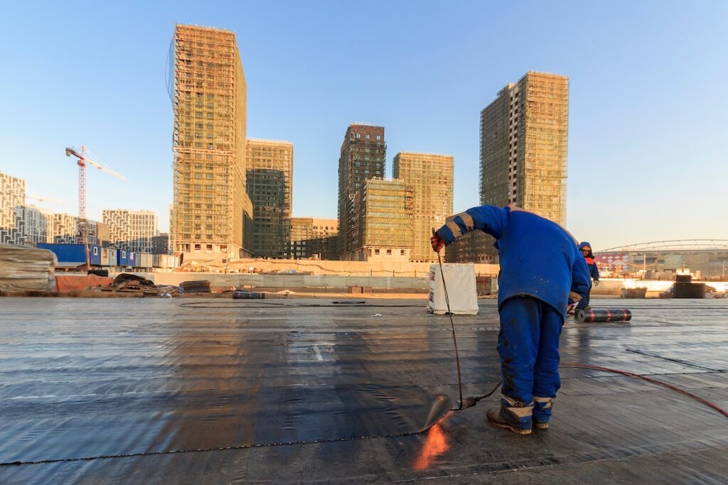 Waterproofing the roof of residential building. Covering roofing material. flat roof 