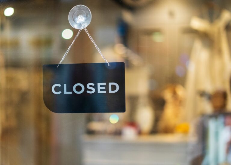 closed sign hanging outside a restaurant, store, office or other