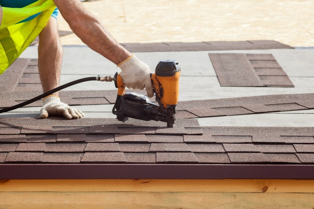 roofer installing shingles